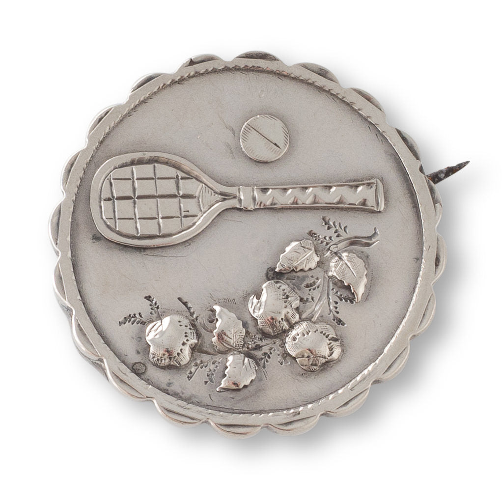 A Circular Silver Tennis Brooch